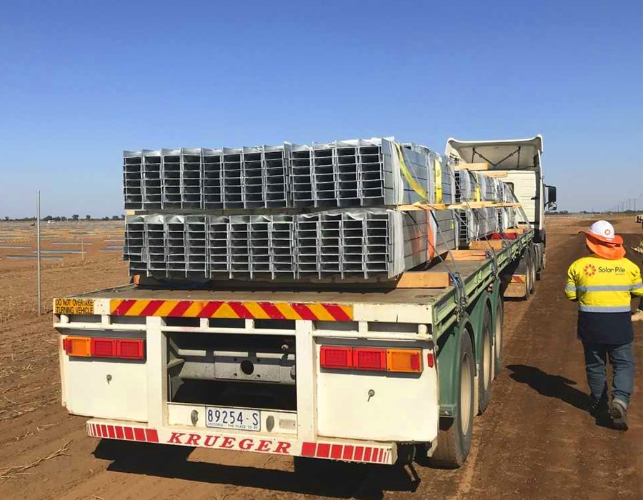 Truck loaded with Solar Pile Int beams heading to Solar Farm